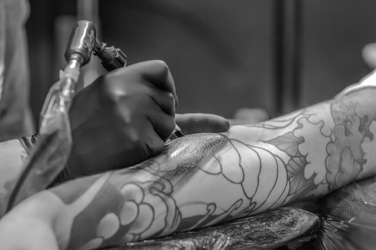 Trainee practising line work and shading under supervision at a Raipur tattoo studio