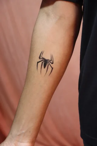 Spider Forearm temporary Tattoo Design | Art and Artist Tattoo Shop Spider tattoo on forearm done at Art and Artist Tattoo Shop, bold black ink tattoo design