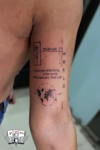 Travel World Quote Tattoo in Tattoo Raipur | Art and Artist Tattoo Studio Travel world quote tattoo on arm done at tattoo raipur studio with minimal black ink design