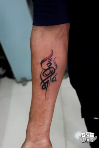 Shiva Name Tattoo on Hand in Tattoo Raipur | Art and Artist Tattoo Studio Shiva name tattoo on hand done at tattoo raipur studio with bold black and red ink