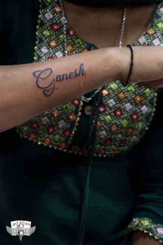 Ganesh Name Tattoo by Tattoo Artist in Raipur | Art and Artist Tattoo Studio Ganesh name tattoo on forearm done by tattoo artist in raipur with clean black ink lettering
