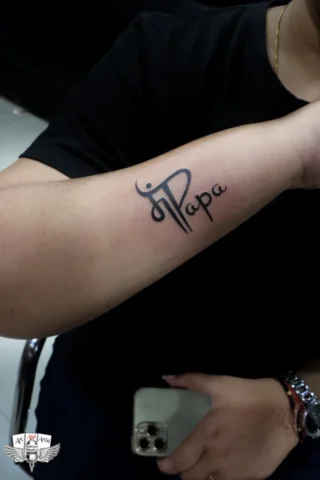 Maa Name Tattoo by Tattoo Artist in Raipur | Art and Artist Tattoo Studio Maa name tattoo on forearm done by tattoo artist in raipur with clean black ink lettering