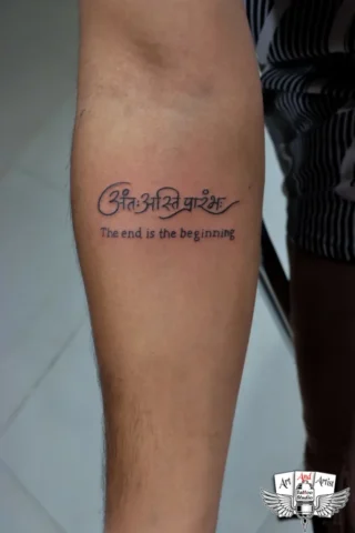 Sanskrit Quote Tattoo by Tattoo Artist in Raipur | Art and Artist Tattoo Studio Sanskrit and English quote tattoo on forearm done by tattoo artist in raipur with clean black ink