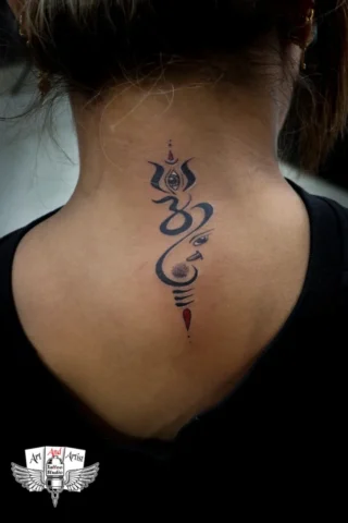 Om Ganesha Neck Tattoo by Tattoo Artist in Raipur | Art and Artist Tattoo Studio Om and Ganesha tattoo on back neck done by tattoo artist in raipur with detailed black and red ink